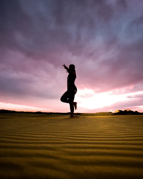 A solo figure on the dune ridge at dusk