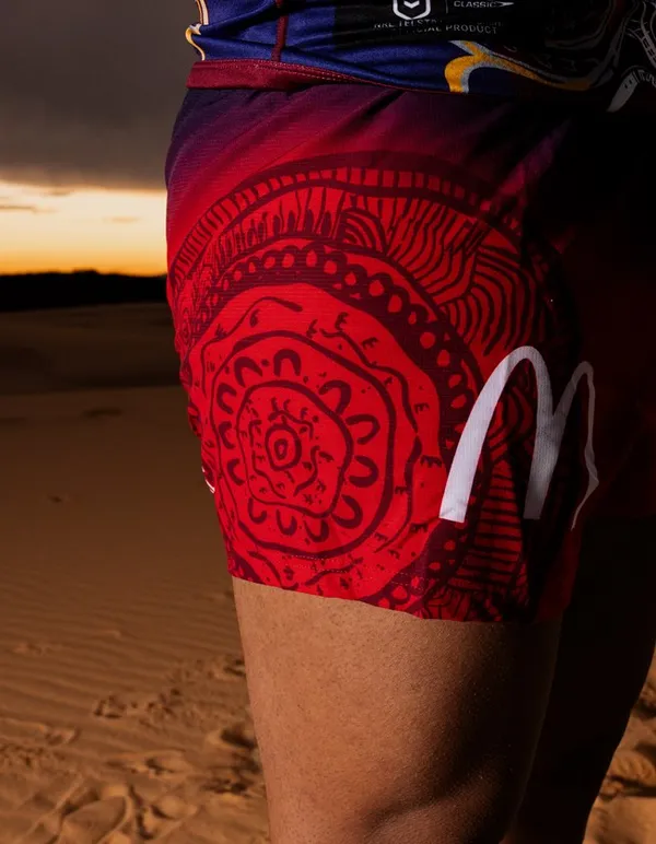 Shorts and hem detail of the Indigenous Round kit on a red ground