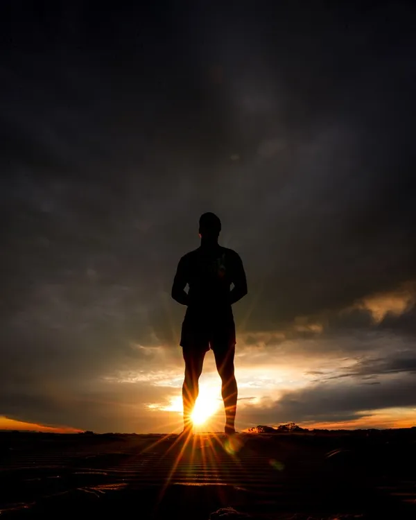 A player silhouetted against the setting sun