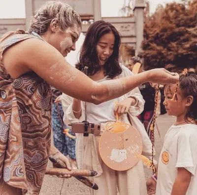 Ochre shared by hand at a cultural gathering