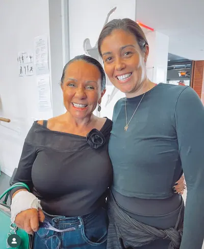 Two women with ochre, at a cultural gathering