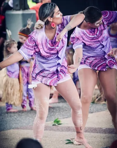 Dancers mid-performance in Midnight Dreaming purple prints