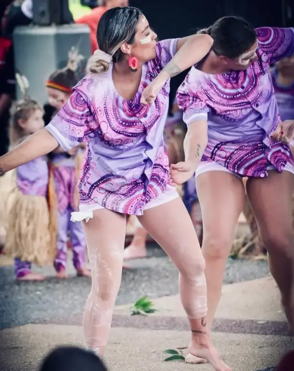 Dancers mid-performance in Midnight Dreaming purple prints