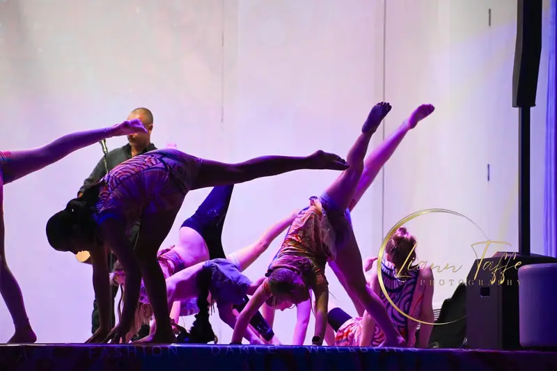 Dancers on stage in Midnight Dreaming uniforms