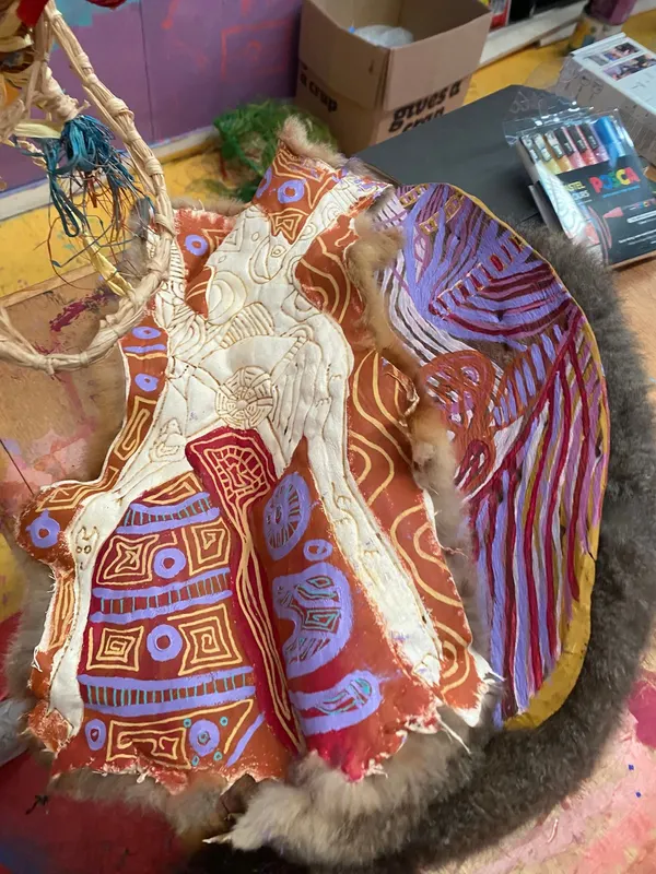 A painted possum-skin cloak by Renae Lamb, on the studio table