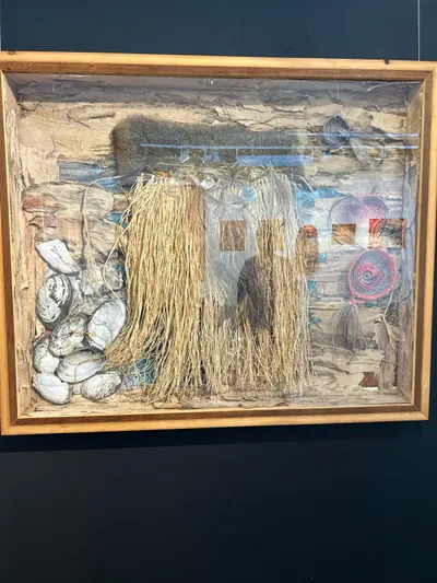 Framed mixed-media weaving by Renae Lamb — grasses, bark and painted stones