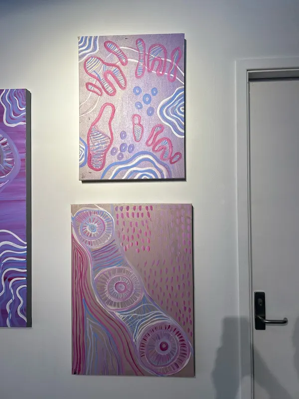 Three paintings by Renae Lamb hung together — pink and lilac