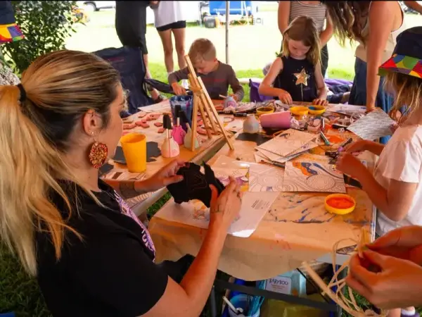 Kids learning to weave at a Midnight Dreaming workshop
